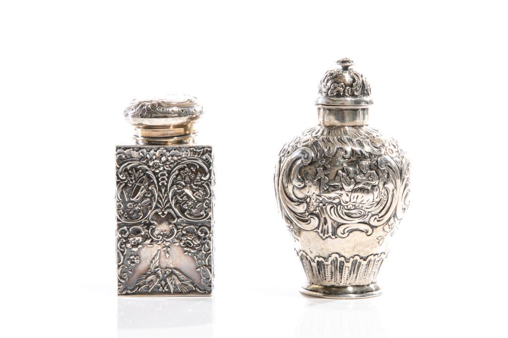 TWO CONTINENTAL SILVER TEA CADDIES, 220g: Variously marked on underside of each, the largest impressed 800 and the smaller impressed "sterling silver". In rectangular and urn forms, each with stopper and embossed foliate detailing. H. of tall