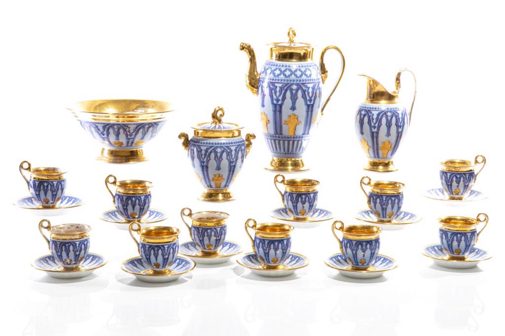 15 PCS SCHOELCHER FRENCH EMPIRE PORCELAIN TEA SET: Hard-paste porcelain coffee set in blue and gold. Transition between neo-classical and gothic revival with design of gothic fretwork armature and neo-classical urns. Eleven cups and saucers, coffee po