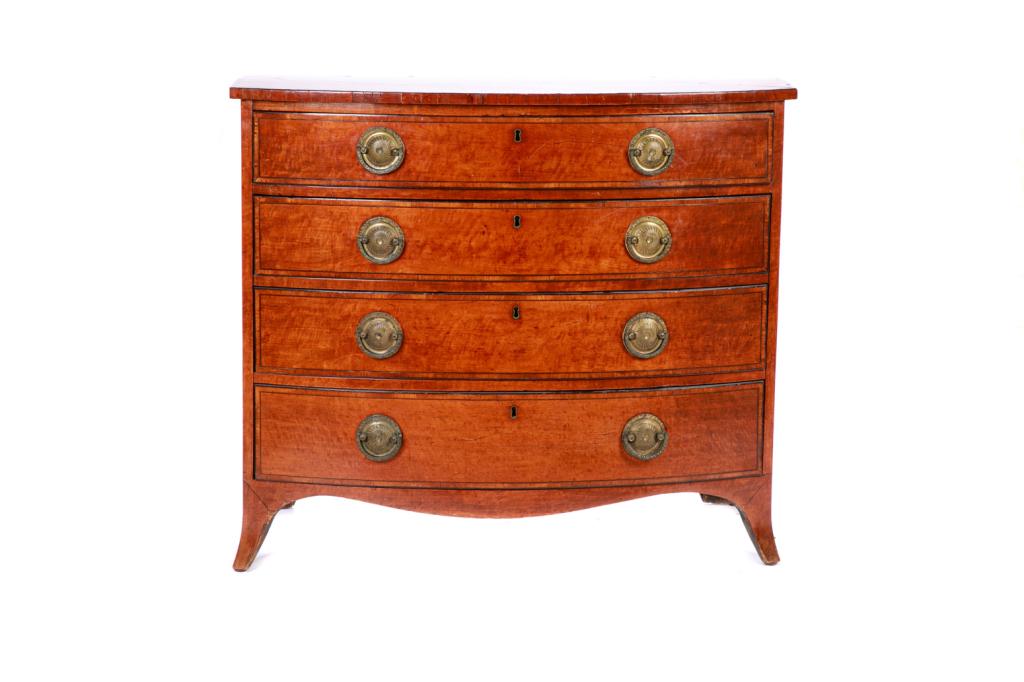 GEORGE III ENGLISH MAHOGANY BOW FRONT CHEST: Four graduated drawers with period brass pulls, ebonized inlay. Straight splayed legs and curved apron. Late 18th/early 19th c. H. 34 W. 39 D. 23 1/2 in