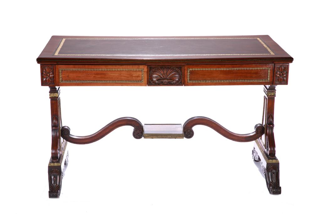 ENGLISH CARVED MAHOGANY LIBRARY TABLE: Bronze mounts and banding accenting the drawers and carved inversed lyre style side, shell detail to the apron, brown tooled leather writing surface, 19th C. H. 30 in W. 48 3/4 in D. 22 1/2 in