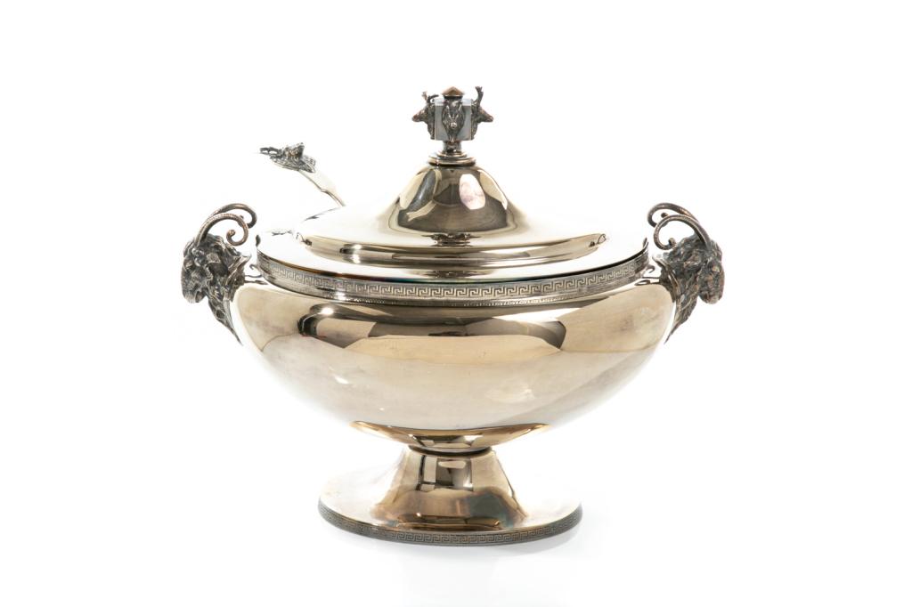 GORHAM SILVERPLATE TUREEN & LADLE: A Gorham (American) silverplate rams head two-handled tureen with a squared finial topped with animal heads. Around the top rim and base of the foot is a Greek key pattern. Marked to base "Gorham MFGC