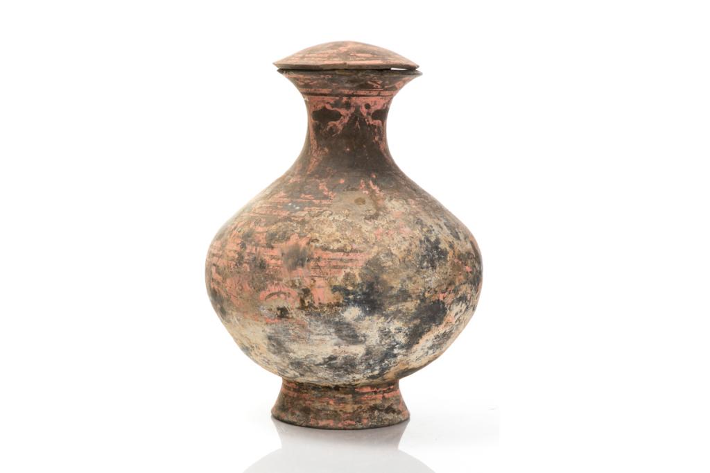 LARGE HAN DYNASTY PAINTED POTTERY HU JAR: Bronze hu form jar painted with red and black pigments with swirling decorative patterns. H. 42cm (16 1/2 in.)