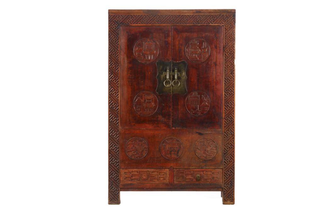 CHINESE ELMWOOD CABINET WITH CARVED ROUNDELS: Chinese elmwood cabinet carved with relief antique motif roundels and key fret border. H. 168cm W. 109cm D. 51cm. Note: All proceeds will go to the Textile Museum of Canada.
