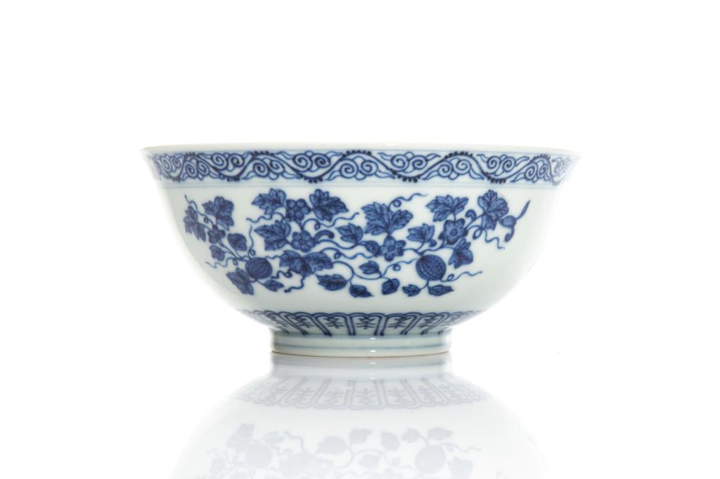 CHINESE BLUE & WHITE PORCELAIN DRAGON BOWL: Base of interior painted with a five-claw dragon roundel. Exterior painted with three fruit and vine clusters. Six character Guangxu mark to base. Dia. 16.5cm (6 1/2 in.) H. 7cm (2 3/4 in.)