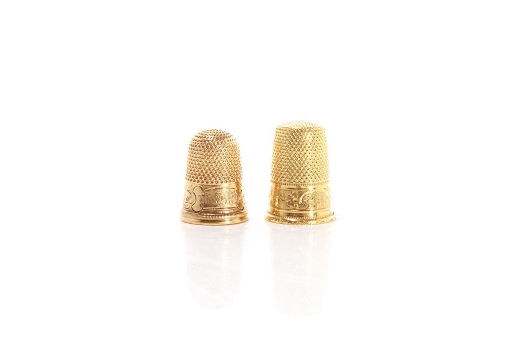 TWO 18K GOLD THIMBLES 9g: Including one marked 18k to interior, likely English or European together with a thimble testing 18k with French hallmarks, 19th C. H. of tallest 2.5 cm (1 in) Proceeds from the sale of this lot will 