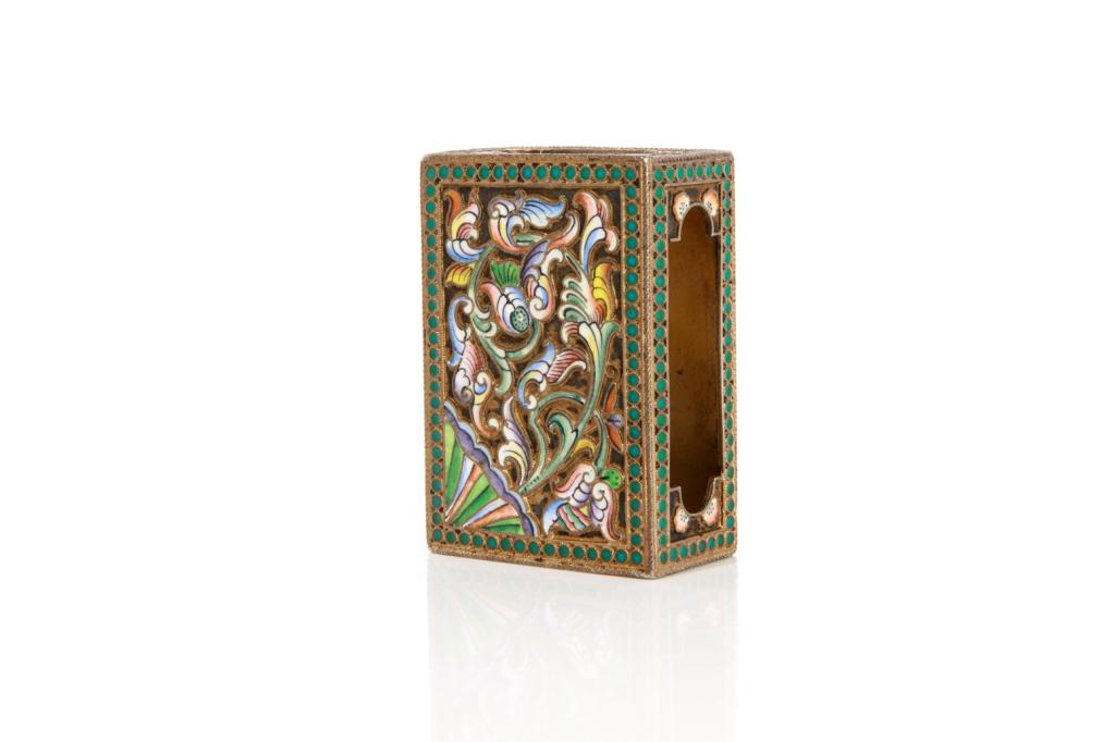 A RUSSIAN ENAMELED MATCH SAFE: A pre revolution silver gilt and polychrome enameled Russian matchbox cover. Moscow 1908 -1917 from the 20th Artel. L. 6 cm x 4.5 cm