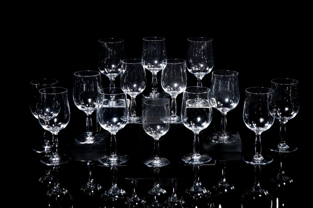 SET OF BACCARAT WINE GLASSES: Fourteen clear wine glasses, ten in larger size and four in smaller size. Each inscribed "Baccarat France" on the underside. H. of larger: 7 1/4 in. H. of smaller: 6 1/4 in.