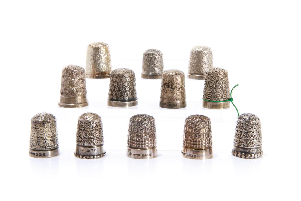 GROUP OF TWELVE SILVER THIMBLES 54g: Twelve English made thimbles, each marked with various hallmarks and inscriptions. Including majority Chester & Birmingham H. of tallest: 2.5 cm (1 in) Proceeds from the sale of this lot will go to th
