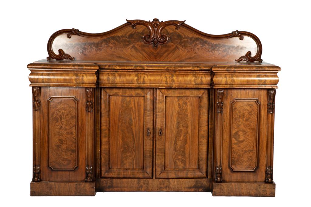 19TH C ENGLISH FLAME MAHOGANY SIDEBOARD: Four doors with four drawers, stepped form with carved column supports, decorative back support. H. 52 W. 70 3/4 D. 25 1/2 in.