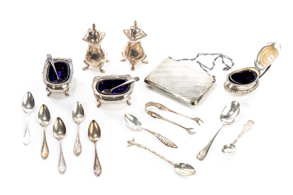 ASSORTED SILVER TABLE ACCESSORIES, 528g: Including one pair of sugar tongs, hallmarked International Sterling; a pair of footed salt shakers, hallmarked Birks Sterling; an English silver card case with internal leather pockets, natural inser