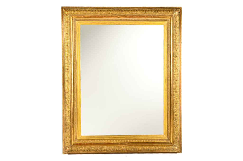 MONUMENTAL ANTIQUE FRENCH GILTWOOD MIRROR: 19th C frame with carved arabesque design and stepped borders. More recent mirror insert available. Marked to reverse. H. 69 in. W. 55 D. 3 1/2 in.