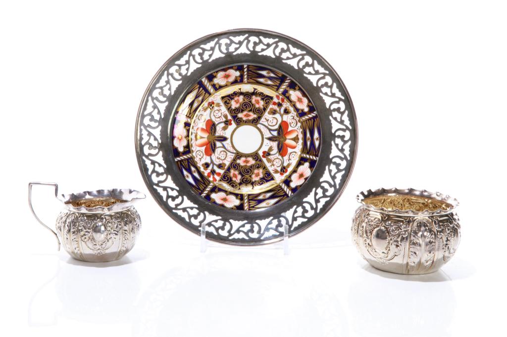 THREE ENGLISH SILVER TABLE ACCESSORIES, 126g: A 19th C English silver cream and matching open sugar, each with heavily chased decoration and a gilt interior. Hallmarked to base: Josiah Williams & Co (George Maudsley Jackson & David Landsborough F