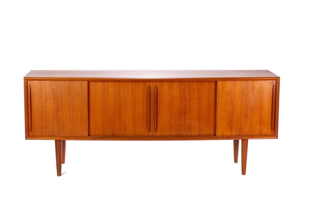 MID CENTURY DANISH TEAK SIDEBOARD: Scandinavian form with four sliding doors; two central doors accented with wood pull handles. The overall form slightly bowed front and raised on four feet. Back stamped Denmark. Drawer interior.H. 32