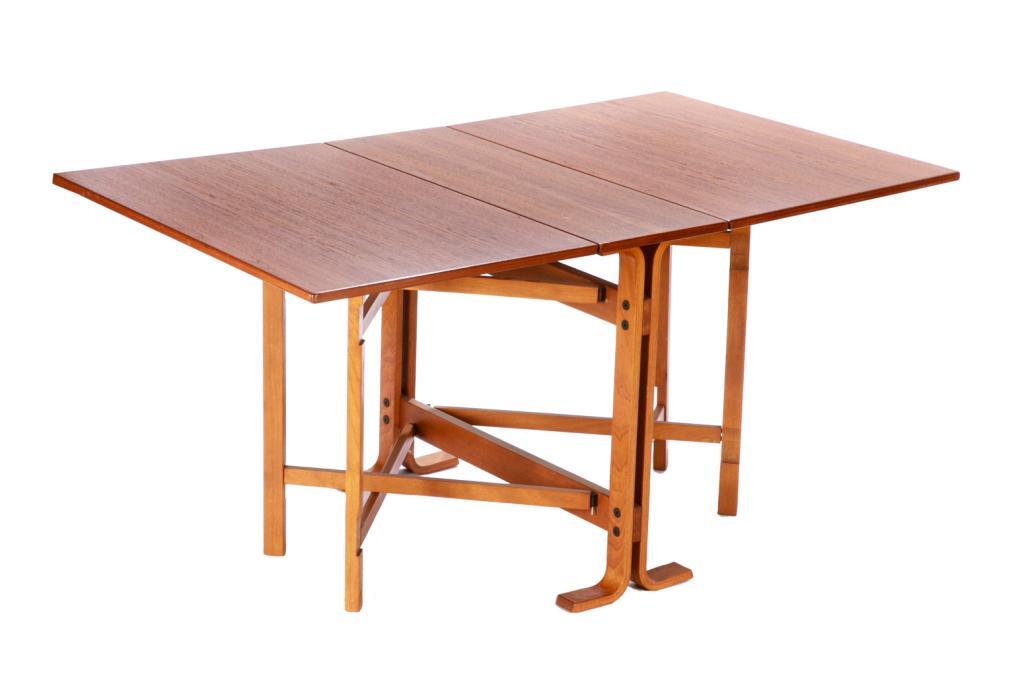 MID CENTURY NORWEGIAN TEAK DROP LEAF TABLE: Adaptable form, opens to reveal two mirrored sided leaves as a large dining table with bentwood lower supports. The table reduces into a compact side table. Stamped Made in Norway. H.28 3/4 W. 12 (clo
