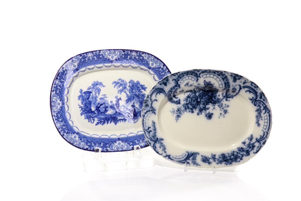 TWO ENGLISH BLUE & WHITE PLATTERS: Including one large Royal Doulton "Watteau" pattern platter, marked and impressed on reverse; and one large flow blue platter, marked on reverse. 19th c.Measurements (Royal Doulton): L. 49 cm (19 1/4