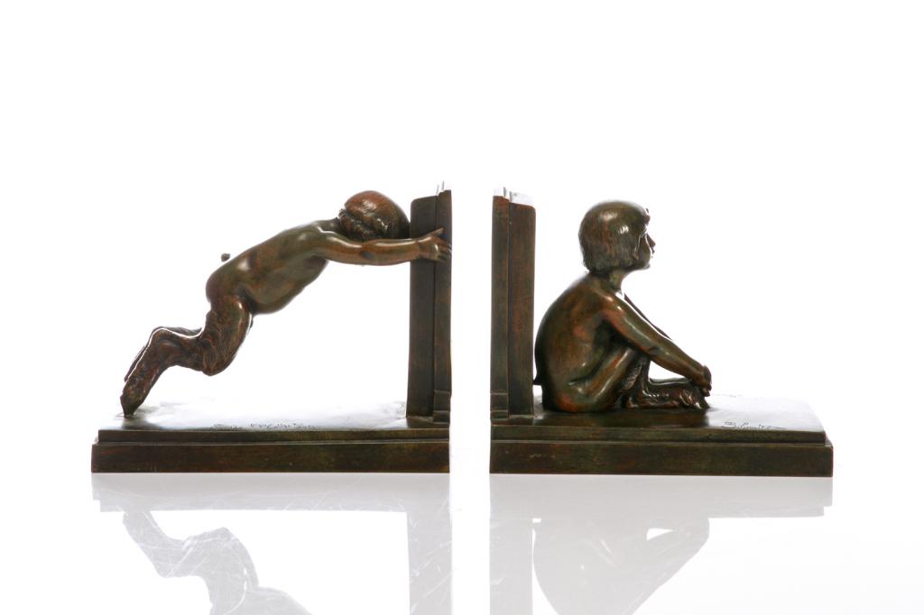 PAIR OF ART DECO PATINATED BRONZE FIGURAL BOOKENDS: French, circa 1920s. Depicting two young faunsWith inscribed signatures to the base of each by Paul Silvestre and Susse Freres foundry with impressed mark, Paris. H. 18 cm (7 1/8 in) L. 22.5 cm (8 7/8