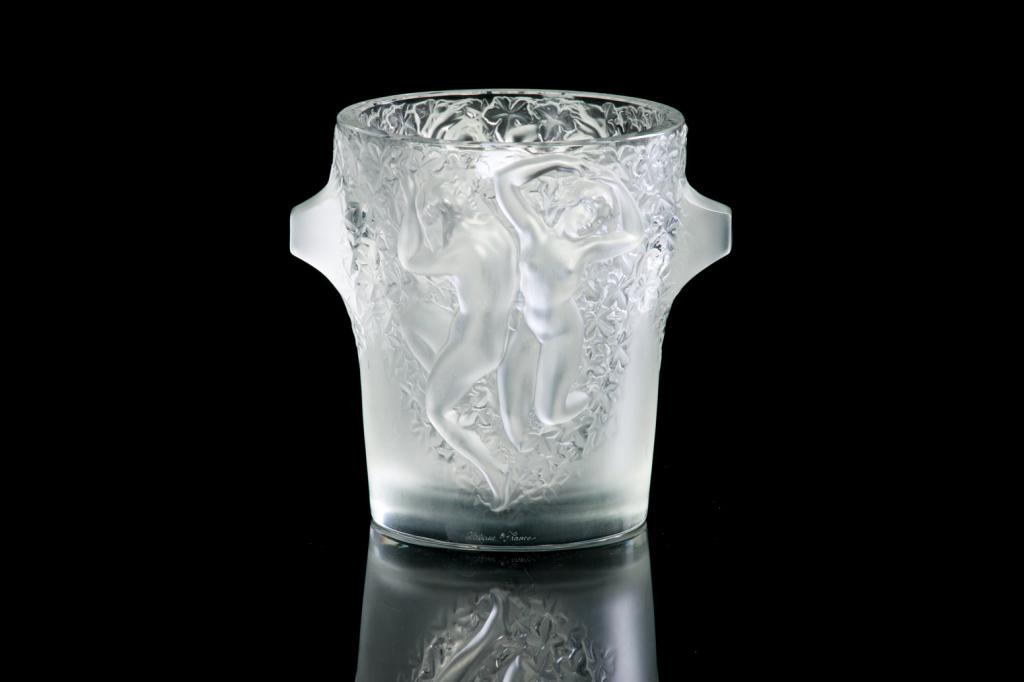 LALIQUE FRANCE FROSTED GLASS GANYMEDE WINE COOLER: French, 20th century glass bucket with frosted Baccante nude figures and grape leaves surrounding. With protruding handles on either side. Inscribed Lalique France along the foot. H. 23 cm (9 in.) Dia