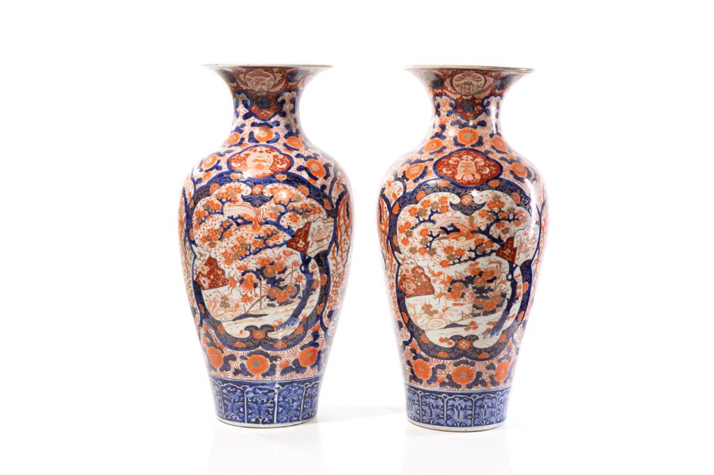 PAIR OF LARGE JAPANESE IMARI PORCELAIN FLOOR VASES: Finely painted with flowers and decorative patterns, underglaze blue lappet band to foot. Gilt details. Meiji period, 19th C. H. 77cm (30 1/4 in.) Provenance: From Chelster Hall Oakville, Ontario by o