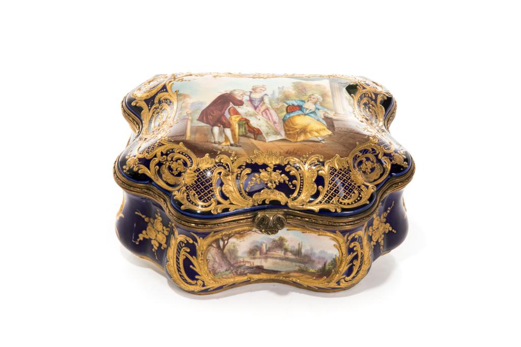 FRENCH HAND PAINTED PORCELAIN CASKET: With figural and landscape scenes surrounded by gilding and ormolu mounts. Cobalt blue borders, impressed with Sevres style marks to the underside. Painted scene on the lid is signed Aube, bottom righ