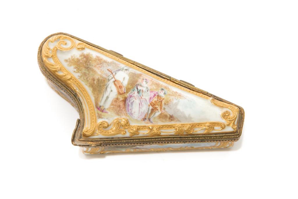 HARP FORM PORCELAIN SNUFF BOX: Attributed to Meissen, though makers mark appears to be ground off / removed. Hinged harp form box with gilded foliate details surrounding the border of the box, with a hand painted figural scene depi