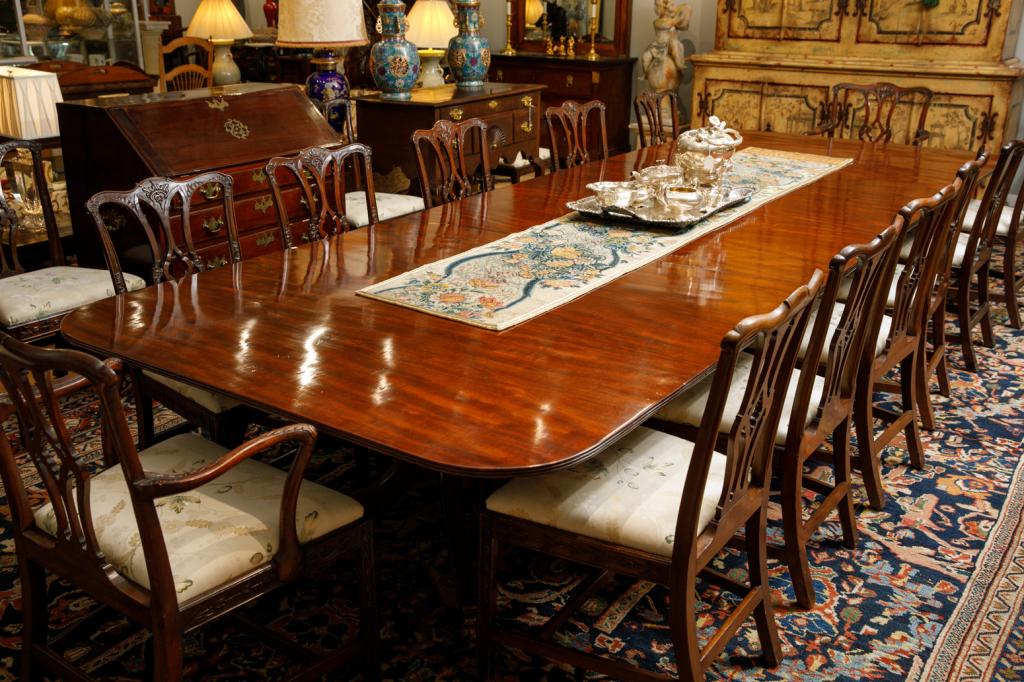 GEORGE III MAHOGANY TRIPLE PEDESTAL DINING TABLE: With a reeded border, the whole raised on baluster columns and reeded splayed legs ending in brass paw castors, c.1795. L. 18' 8" W. 5' Provenance: The Estate of the Late Senator E. Leo Kolber Westmou