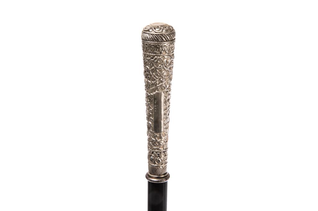ANTIQUE SILVER HANDLED EBONIZED WALKING STICK: Opens to reveal hidden sword. Silver handle with foliate details in relief, gadrooned trim. Impressed with R marking and 925, concealed sword inside cane with stylized scrolling design on either side