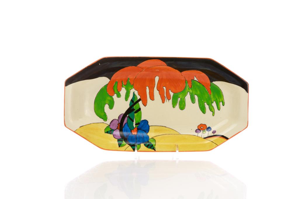 CLARICE CLIFF WOODLAND ART DECO POTTERY PLATTER: English, 20th century. Elongated octagonal form with cream ground, hand painted abstract landscape design in orange, green, black and yellow. Inscribed maker and pattern name to the underside of the d