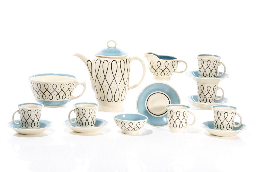 SUSIE COOPER ELEGANCE TEN PIECE COFFEE SERVICE: English, c. 1930s Crown Works Burslem marked with maker on underside of each piece. Cream ground pottery with blue borders, black looped design surrounding. Comprising: Six demitasse cups & saucers Co