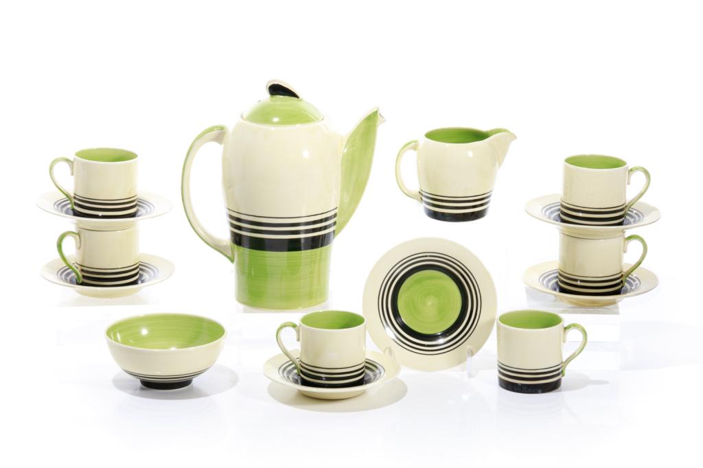 SUSIE COOPER GREEN BANDED KESTREL COFFEE SERVICE: English, c. 1930s. 9 piece cream ground pottery set with graduated black bands and apple green accents. Marks on underside of each piece. Comprising: Six demitasse cups & saucers One sugar bowl, cream