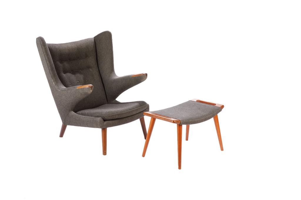HANS WEGNER PAPA BEAR CHAIR WITH OTTOMAN: Danish mid-century, designed in 1951 and manufactured by AP Stolen. Wing chair form with grey wool upholstery. Matching teak and upholstery ottoman. Maker's mark to underside of ottoman. Denmark, mid-