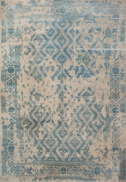 CONTEMPORARY WOOL ELTE CARPET: Tibetan style, light grey ground with overall light blue foliate design and Intentional void pattern. 13' 5" x 9' 9"