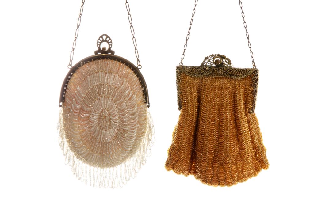 TWO ART DECO BEADED EVENING PURSES: A vintage Czech Art Deco oval white beaded hand bag with alternating white and transparent bands, beaded fringe. Bronzed metal frame with ball and decorative deco style clasp, impressed "Made in Czech