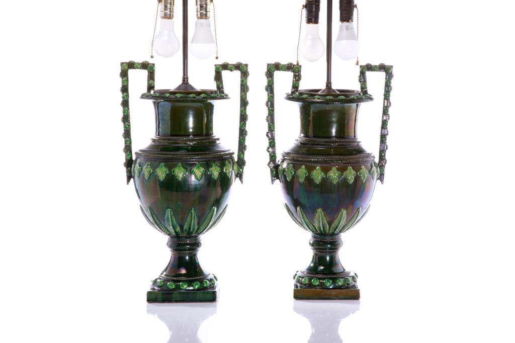 PAIR OF ANTIQUE MAJOLICA POTTERY TABLE LAMPS: Green glazed urn form with decorative floral design. Provenance: The Estate of the Late Senator E. Leo Kolber Westmount, Quebec.