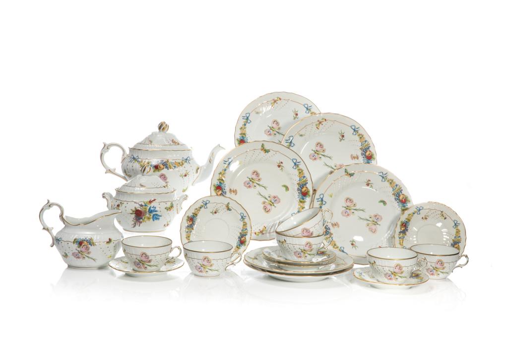 RICHARD GINORI PORCELAIN 15 PIECE TEA SERVICE: Italy, 20th century. White ground tea service with gilded trims and molded basket weave form banding. Polychrome floral and butterfly decorative motives. Makers marks to the undersideof each piece. Se