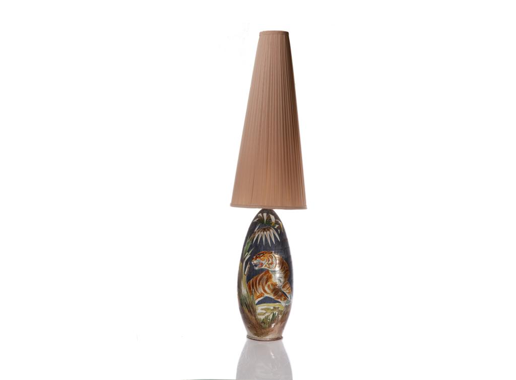 MID C SWEDISH MARIAN ZAWADZKI POTTERY TABLE LAMP: A vintage glazed pottery vase converted to table lamp. One side depicting a hunting tiger, the other depicting a charging water buffalo. Signed "Marian 1962", possibly for Tilgman Keramik. H. to top o