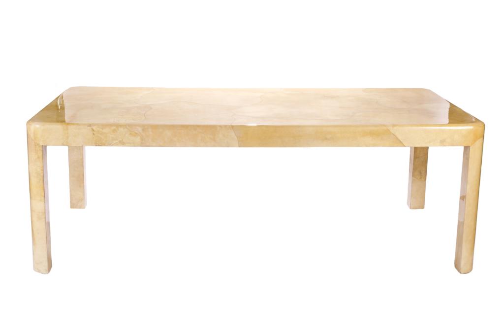 KARL SPRINGER RECTANGULAR DINING TABLE: Mid-century modern dining table. Cream parchment-clad rectangular top on curved legs. United States, Karl Springer, c. 1960s. Sales label on leg. H. 29" W. 83" S. 41 1/2"