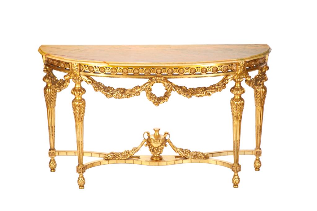 LOUIS XVI STYLE GILTWOOD AND MARBLE CONSOLE TABLE: Demilune console table with ornate giltwood base, tapered reeded legs, and embellished with swags, rosettes and an urn-form ornament on the cross-stretcher. With a pink striated marble top.20th c. H. 