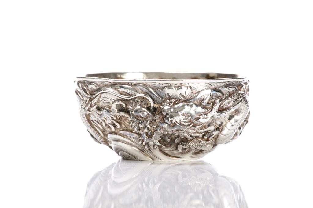 JAPANESE REPOUSSE SILVER BOWL WITH DRAGONS: Marked Samurai Yokohama 1000 to base. Meiji period. Dia. 12.5cm (5 in.) Weight: 125g. Provenance: Interior with D&J Ritchie Ltd. sticker.