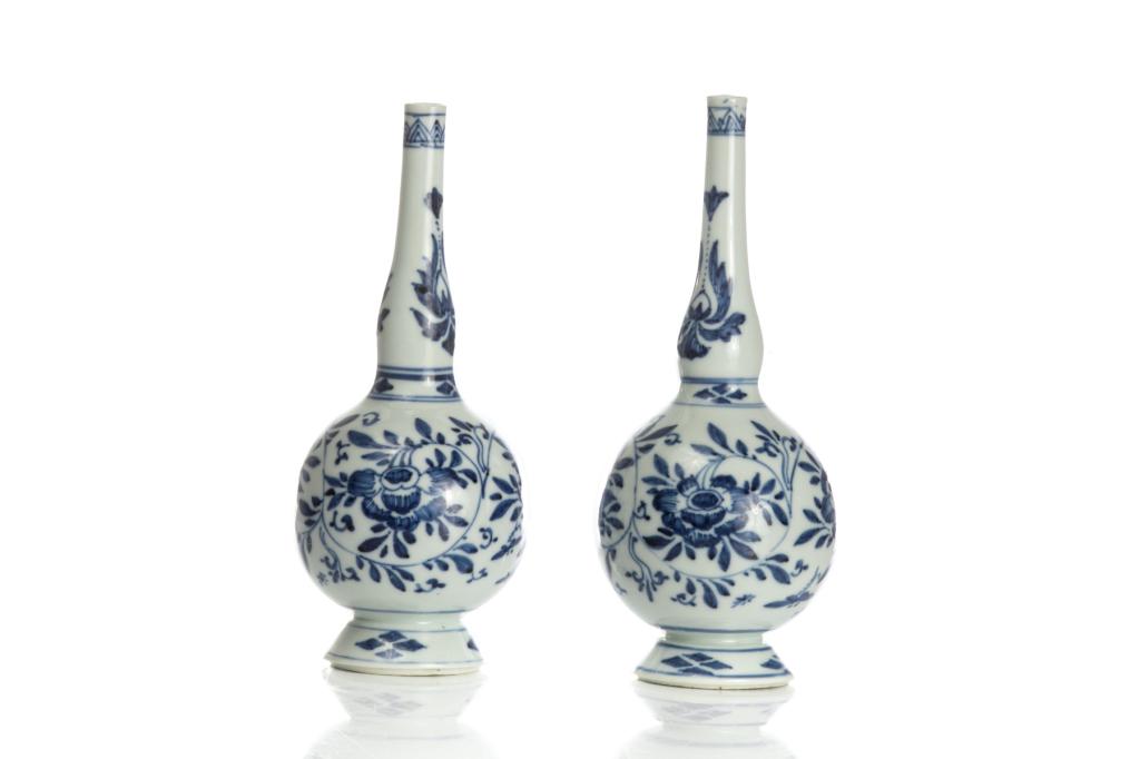 PAIR OF BLUE & WHITE PORCELAIN ROSE WATER BOTTLES: Painted with flower sprays to body and decorated bands. Qing dynasty Chinese export, Kangxi period, 18th C. H. 19cm (7 1/2 in.) Provenance: From Chelster Hall Oakville, Ontario by order of the Estate 