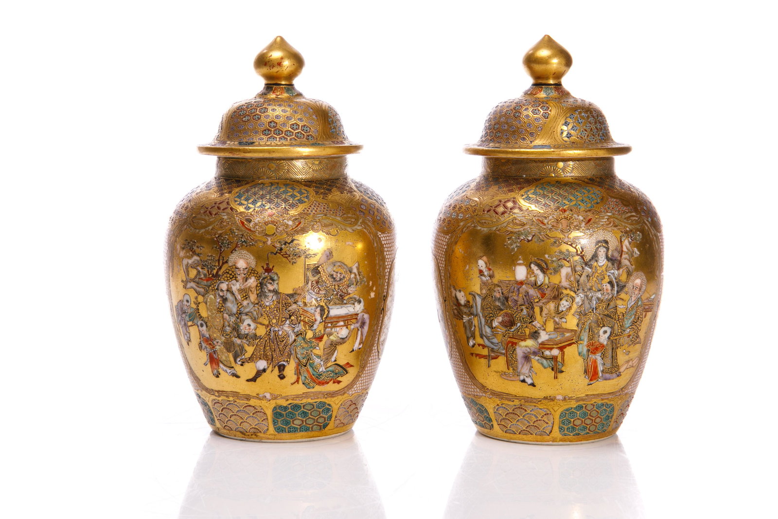 PAIR OF JAPANESE SATSUMA POTTERY COVERED JARS: Finely painted with household interior scenes and heavenly immortal scenes, separated by floral cartouches. Base marked Shioyama. Meiji period, 19th C. H. 12.5cm (5 in.)
