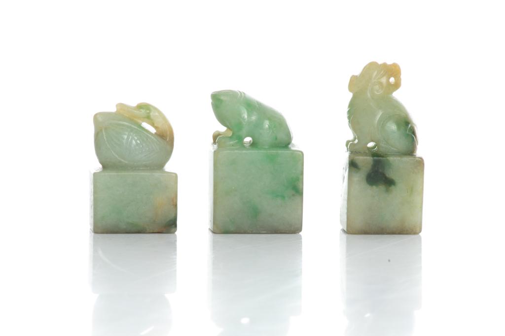 THREE CHINESE JADEITE CARVED SEALS: Mythical beast, frog, and mandarin duck form finial, seal faces carved. Tallest: 4cm (1 1/2 in.)