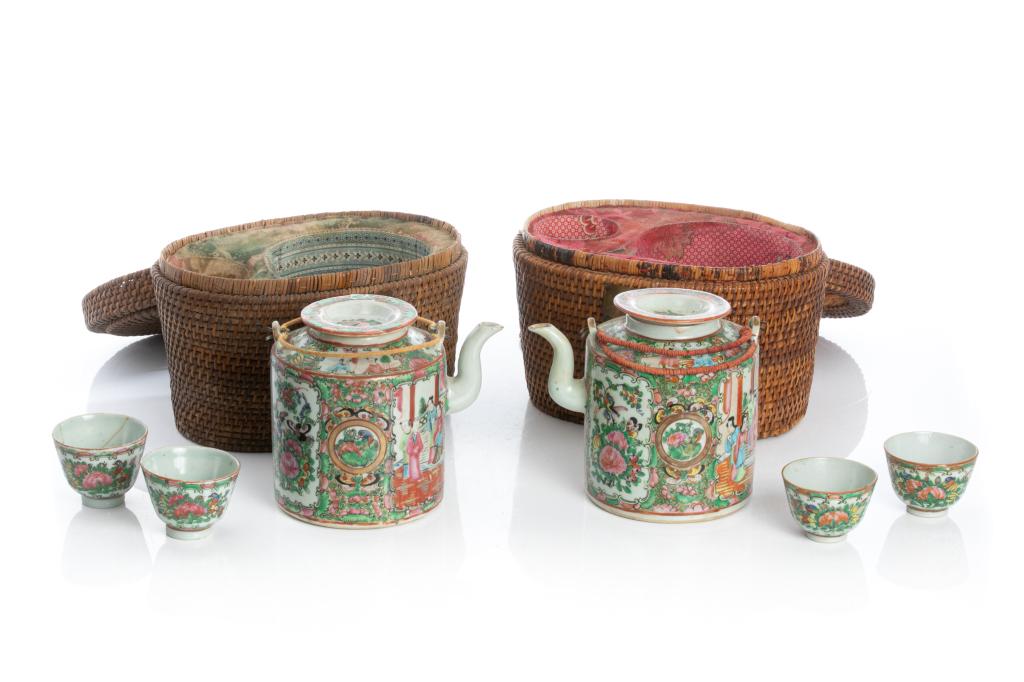 TWO EXPORT CANTON FAMILLE ROSE PORCELAIN TEA SET: Two basket set each with a large teapot and two tea cups. Painted with alternating family and birds and flower scenes separated with gilt ground floral borders. Including original woven carrying case.