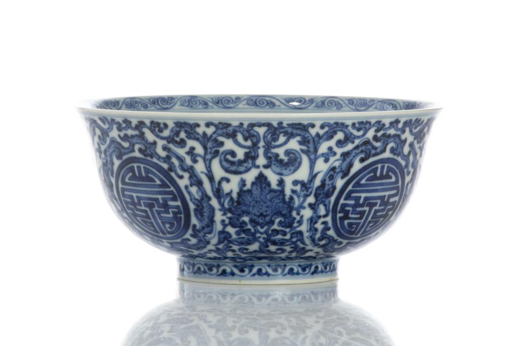 CHINESE BLUE & WHITE PORCELAIN SHOU BOWL: Painted with lotus spray and stylized Shou roundels. Six character Qianlong mark to base. Top dia. 15cm (6 in.) H. 7cm (2 3/4 in.)
