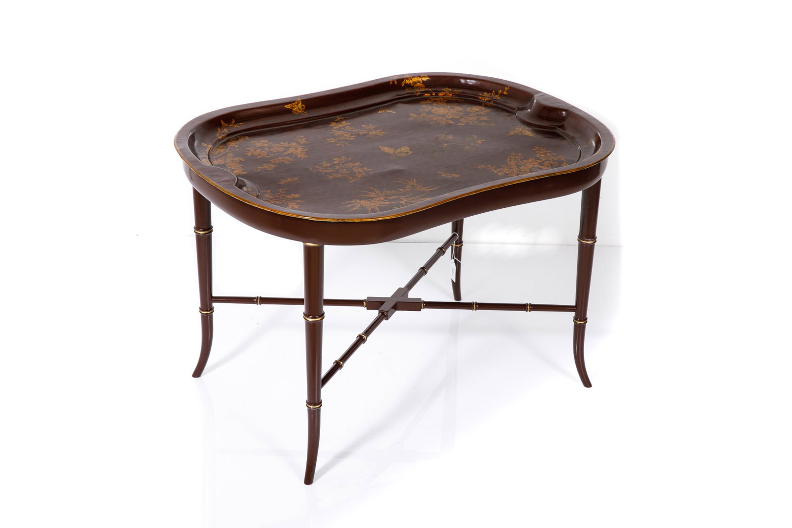 19TH C ENGLISH HAND PAINTED MACHE TABLE: A burgundy ground tray on fitted stand. The tray with floral, foliate, and butterfly details, as well as gilded trim. The stand with X-form stretcher, the legs with gilded accents. H. 19 5/8" W. 29 1/