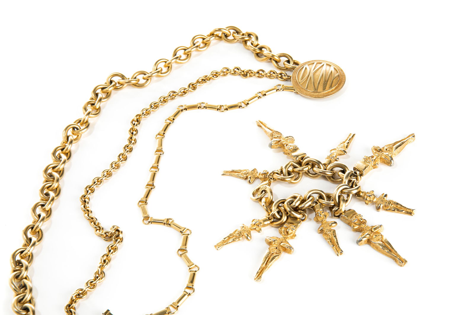 VINTAGE DONNA KARAN NECKLACE AND BRACELET: Gold-toned triple chain necklace with logo pendant marked "DKNY". Together with a gold-toned link bracelet with nine figural Mayan charms. Marked "DKNY". c. 1990s L. (necklace fastened): approx. 43cm
