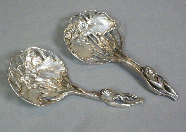 TWO NOMURA JAPANESE SILVER IRIS SPOONS: Two fine Japanese silver iris spoons with applied decoration and high relief. Both signed to back 'Nomura'. L 16 cm (6 3/8 in), 114 grams.