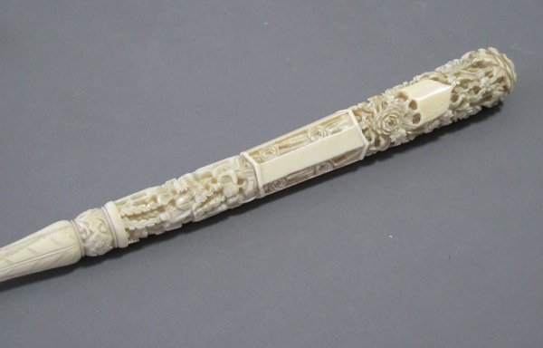 CHINESE EXPORT IVORY PARASOL HANDLE: Chinese export ivory parasol handle. Heavily carved with flowers and figures. 19th century. L 30.3 cm (11 7/8 in). Provenance: The Estate of Mr. John Henry Stuart Gooderham, Toronto.
