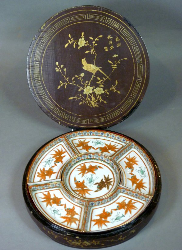 CHINESE FAMILLE ROSE PORCELAIN DIVIDED DISH: Famille rose porcelain divided dish set in circular brown lacquer case. China, early 20th century. D 30.5 cm (12 in).