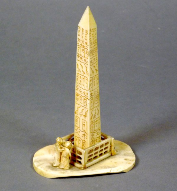 CARVED IVORY OBELISK AND FIGURES, CHINA OR JAPAN: Carved Ivory obelisk with figures, probably Chinese, 19th century. H 14 cm (5 1/2 in).Provenance: The Estate of Mr. John Henry Stuart Gooderham, Toronto.