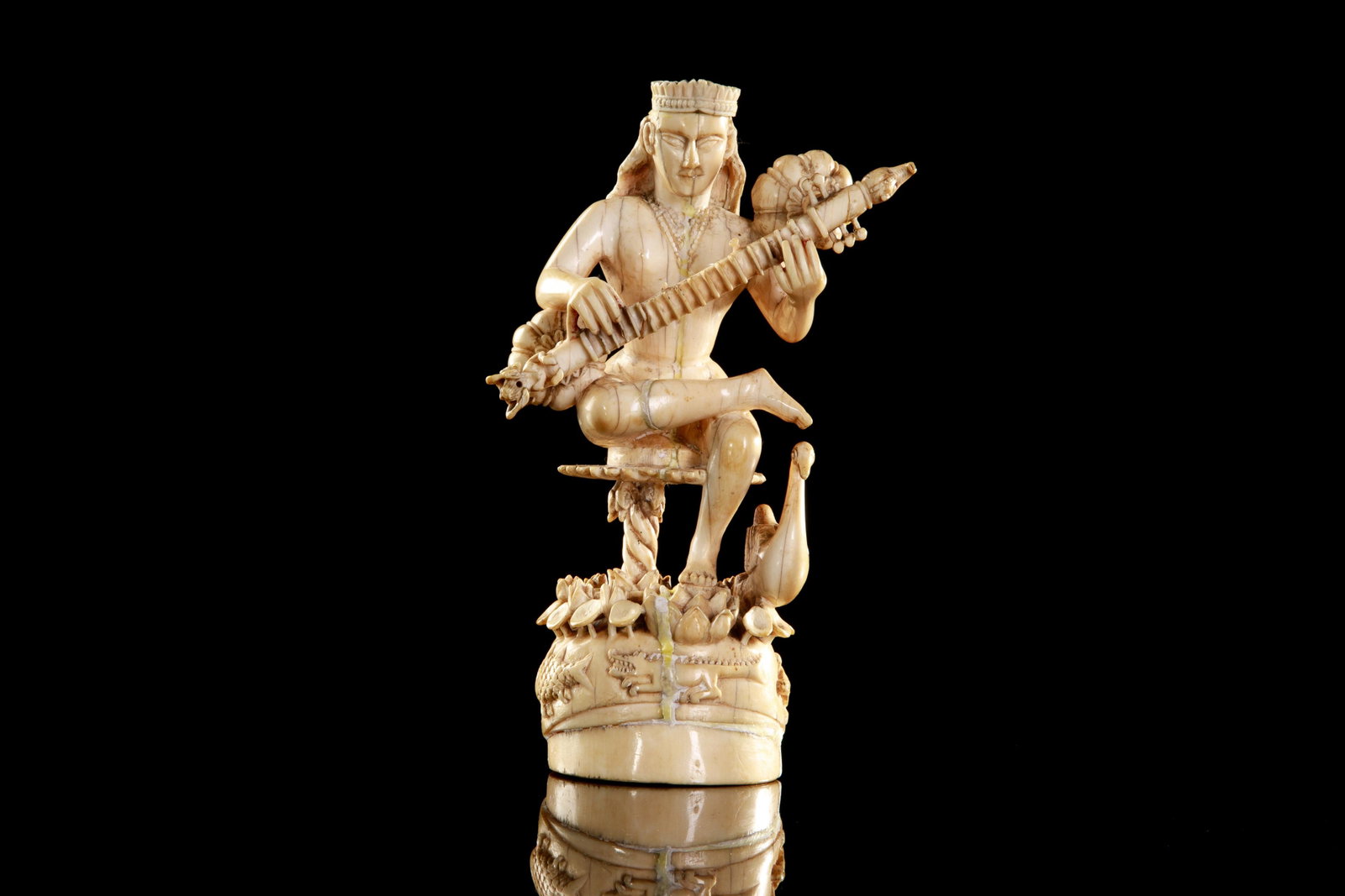NATURAL CARVED FIGURE: Early 19th C, seated female musician, with long flowing hair and crown, with goose at base carved with fish and turtles. H. 16.4 cm (6 1/2 in.) Provenance: Held privately in an important West Coast co